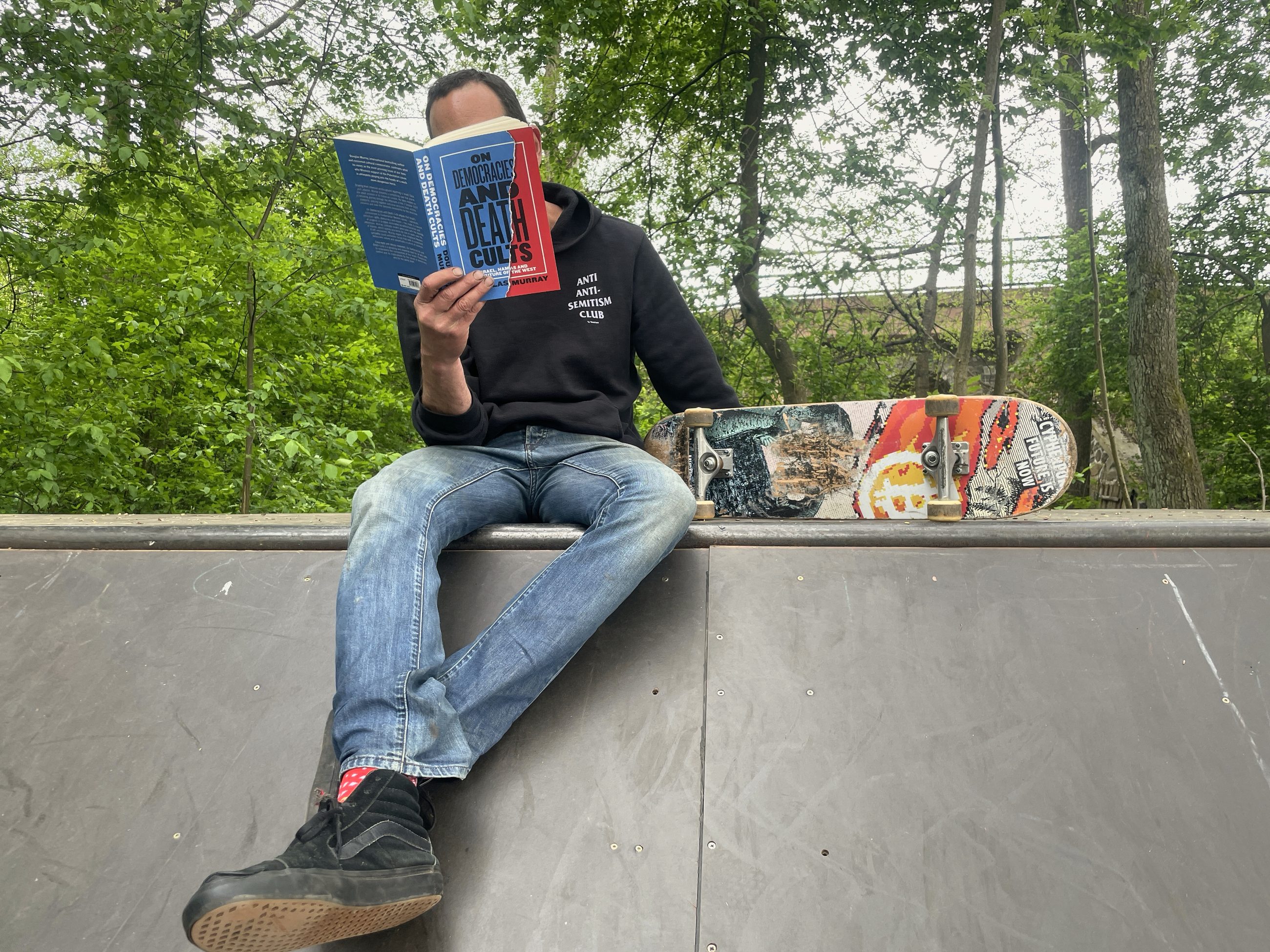 At the cottage — reading and skateboarding
