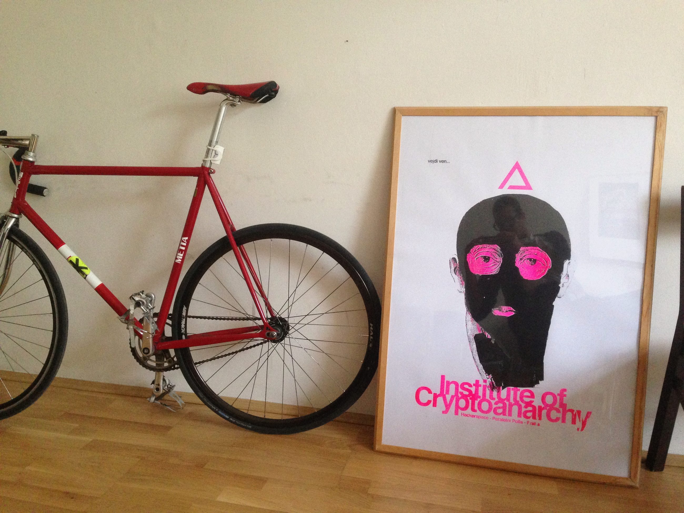 My fixed-gear bike and the Institute Of Cryptoanarchy print at Paralelní Polis, 2015